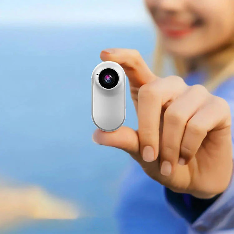 Close-up shot showing the front-facing lens of the portable mini camera.