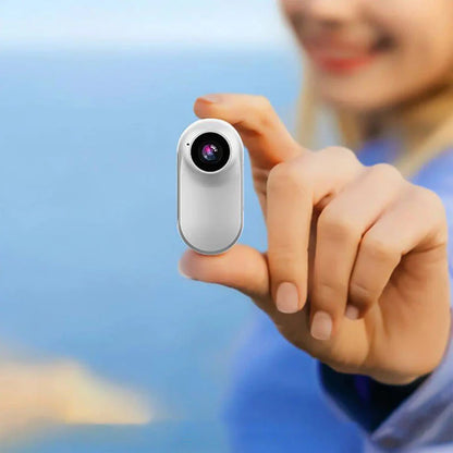 Close-up shot showing the front-facing lens of the portable mini camera.