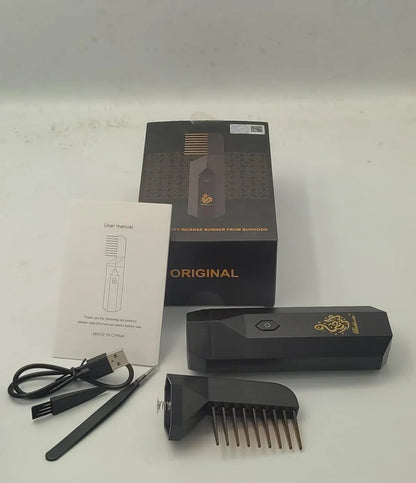 Black electronic device with comb-like attachment, packaging, and USB cable on a white background