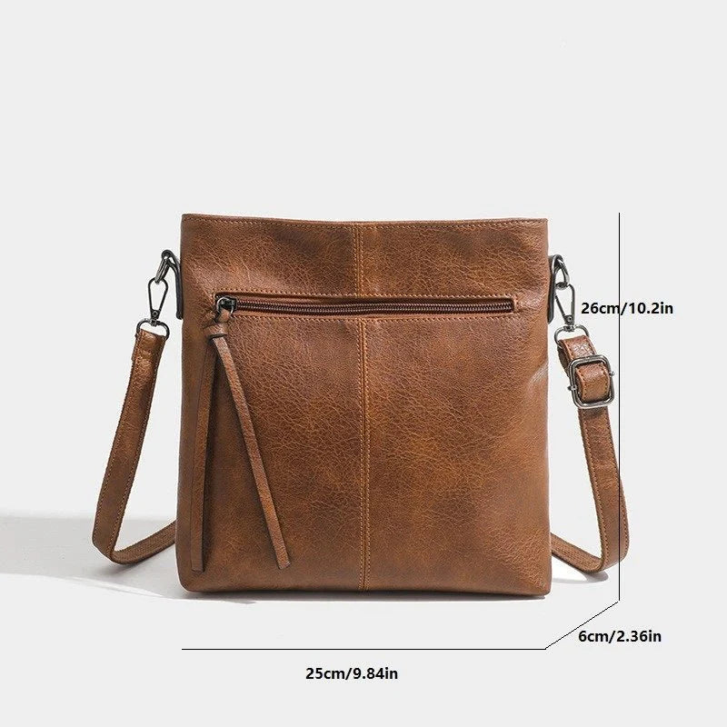 Brown leather crossbody bag with measurements on a white background