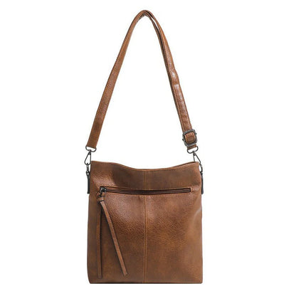 Brown leather handbag with a shoulder strap on a white background